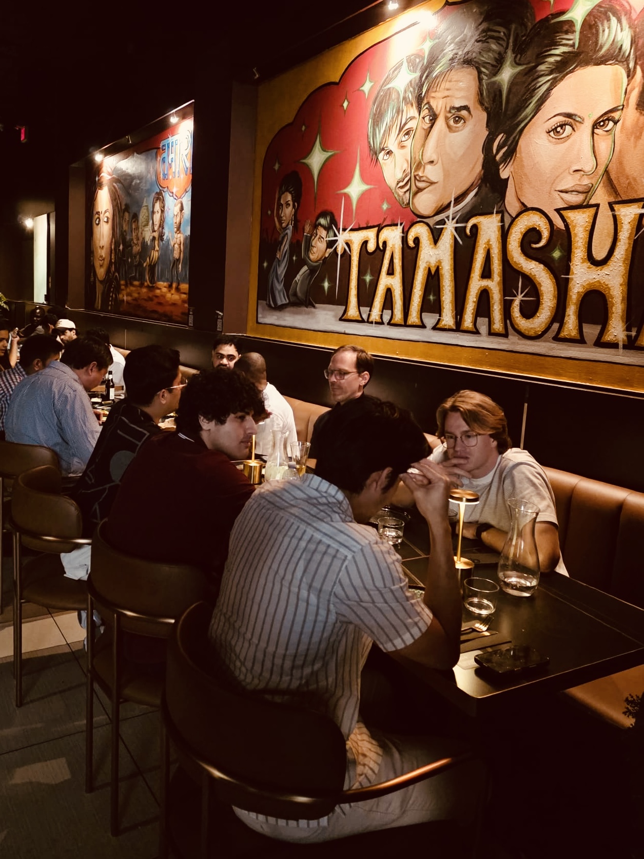 Founders talking along a long banquette table