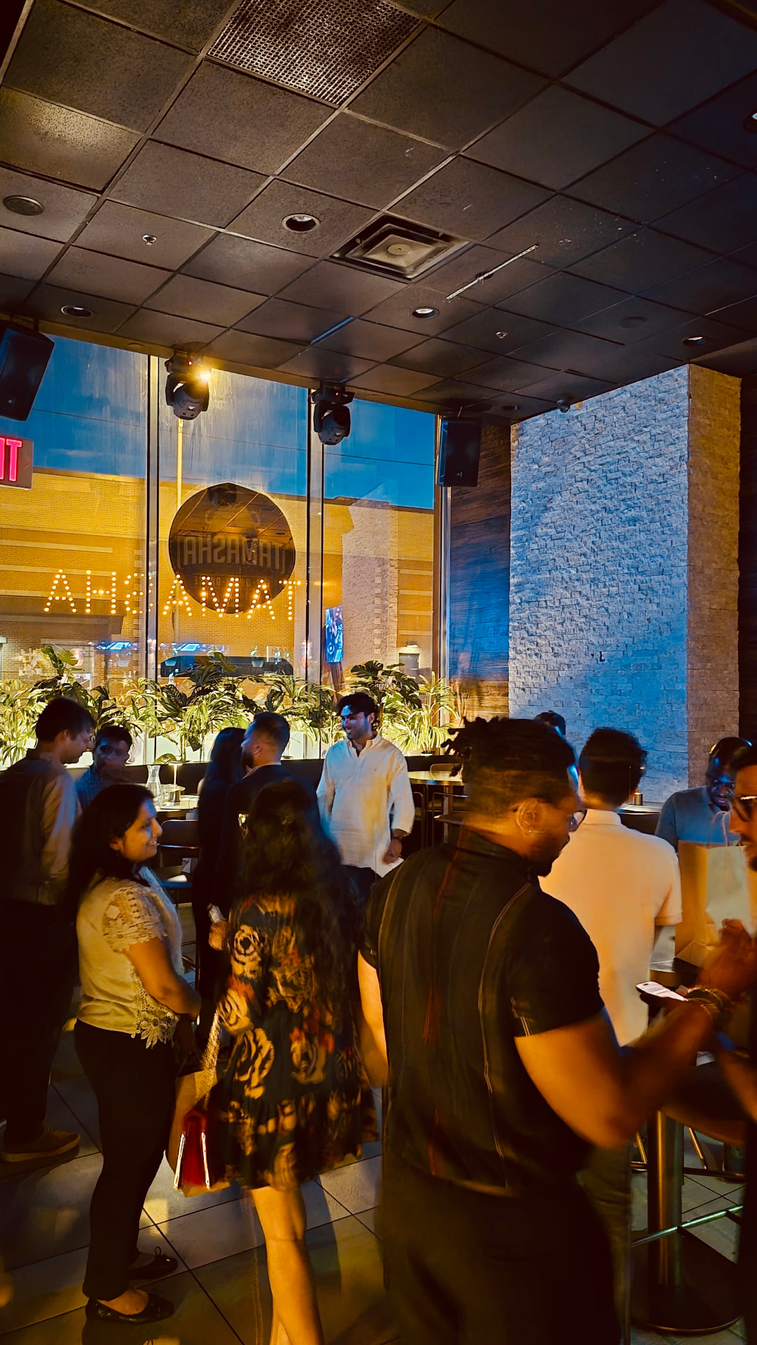 Guests mingling in a restaurant foyer before dinner