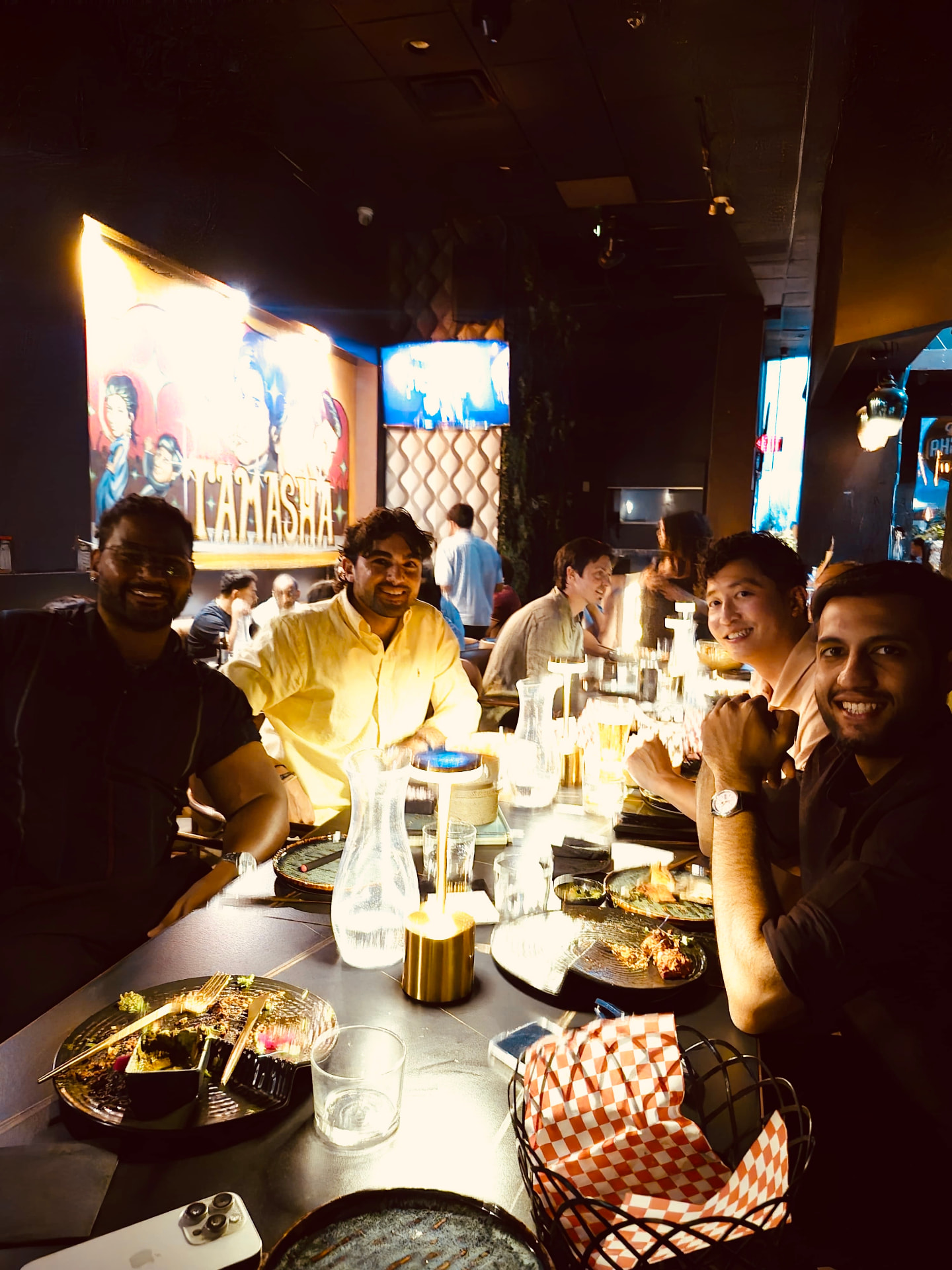 Four founders smiling at the table at the end of dinner