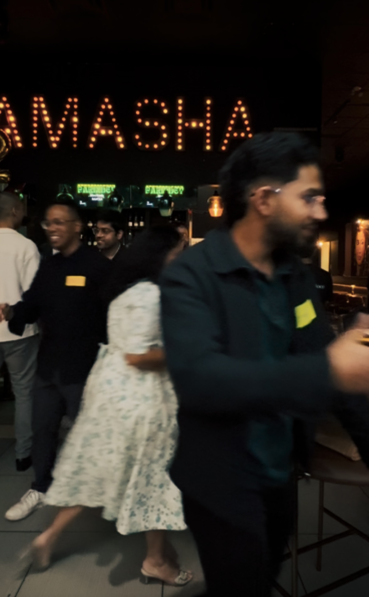 Guests mingling under the marquee lights